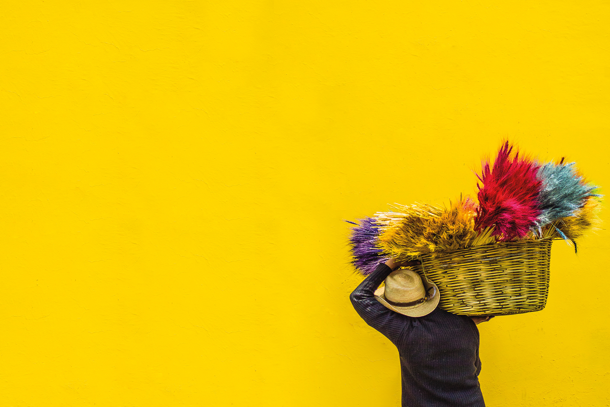 A man carrying a basket of flowers in Cuba.