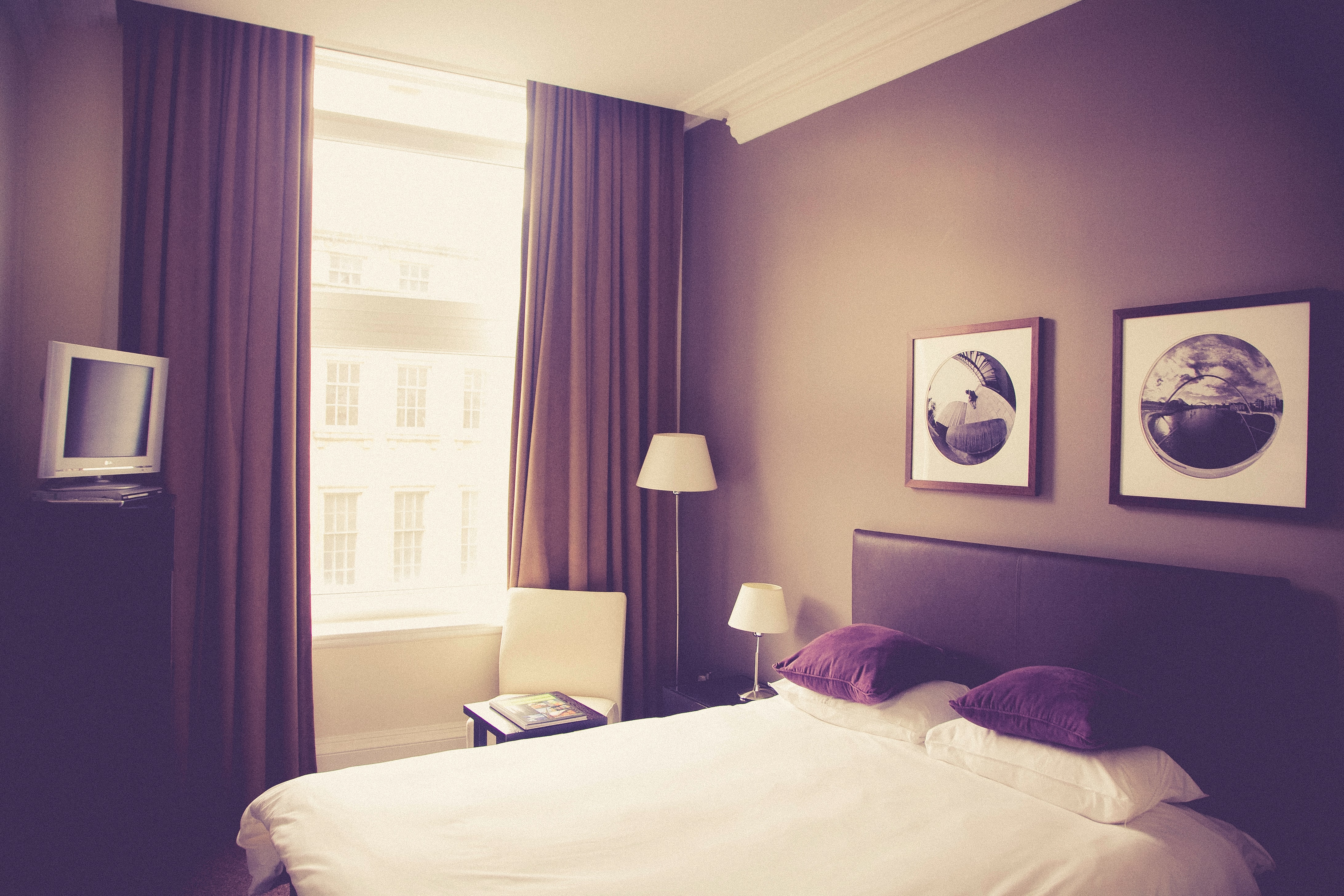 A hotel room with a single queen bed.
