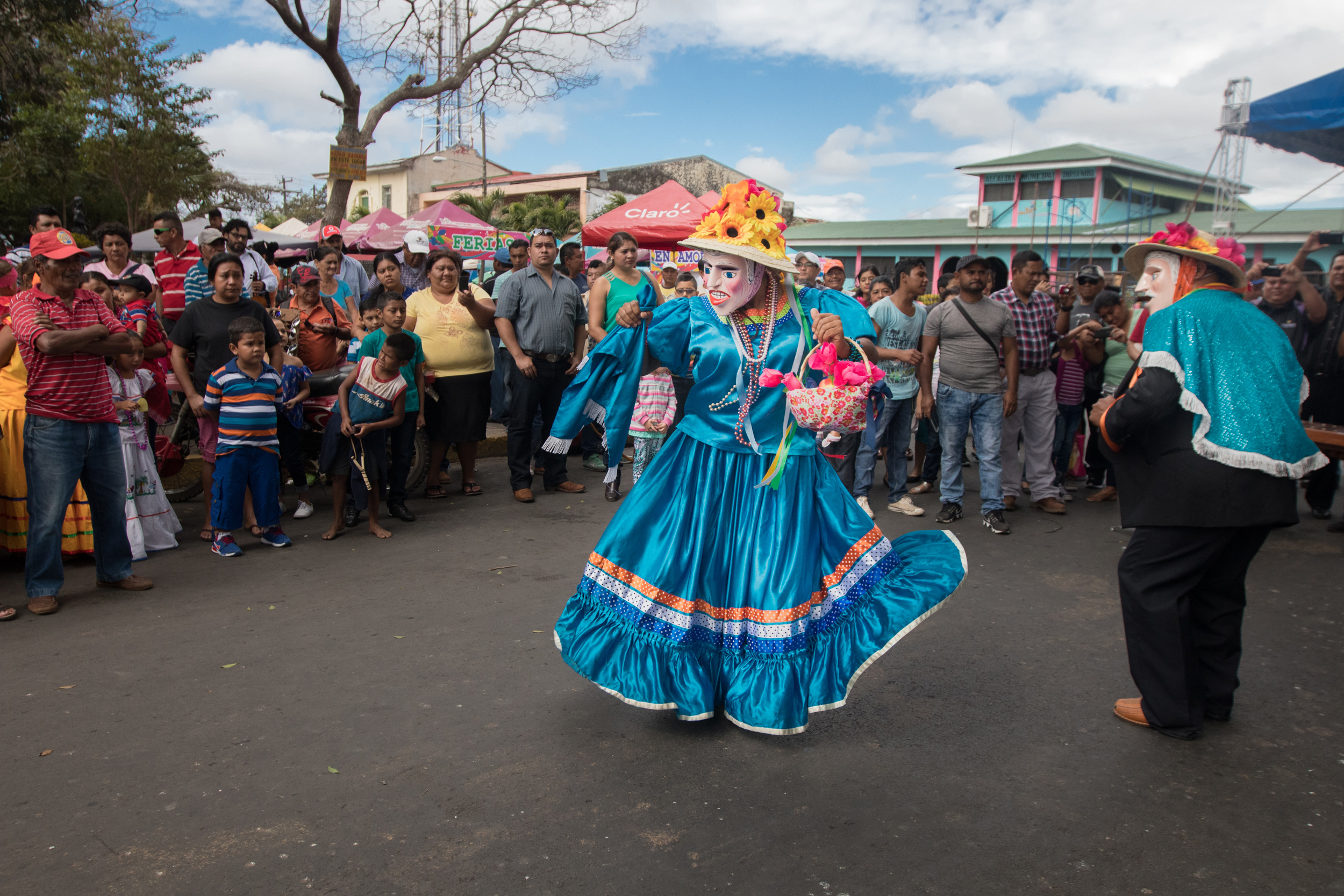 Dancers in traditional costumes in the street.