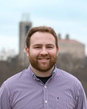 Photo of Alec Graham with KU campus buildings and trees in background